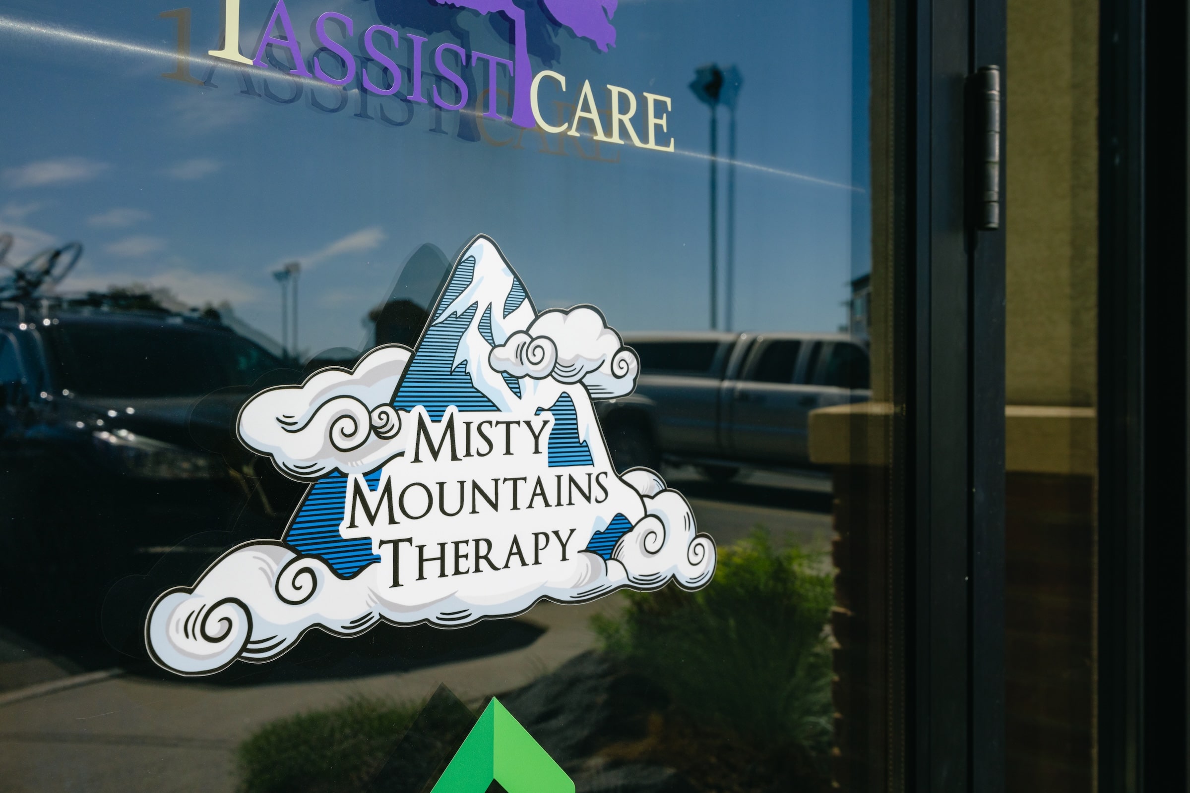 Picture of the glass office door with the Misty Mountains Therapy logo in the center.